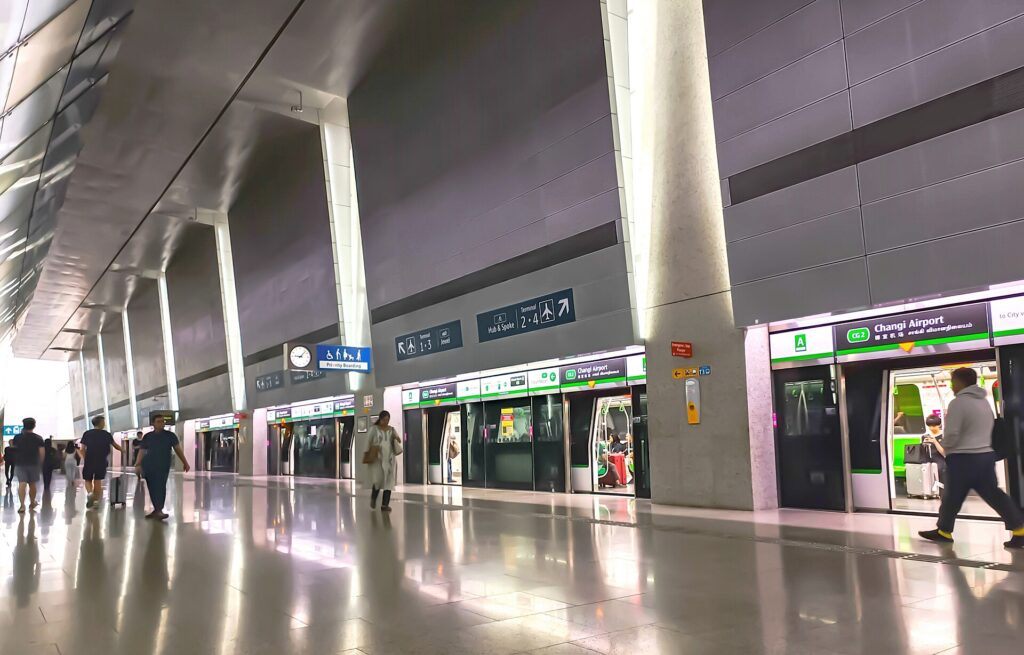 ชานชาลาสถานีรถไฟ MRT Changi Airport พร้อมรถไฟและป้ายเชื่อมเทอร์มินัล